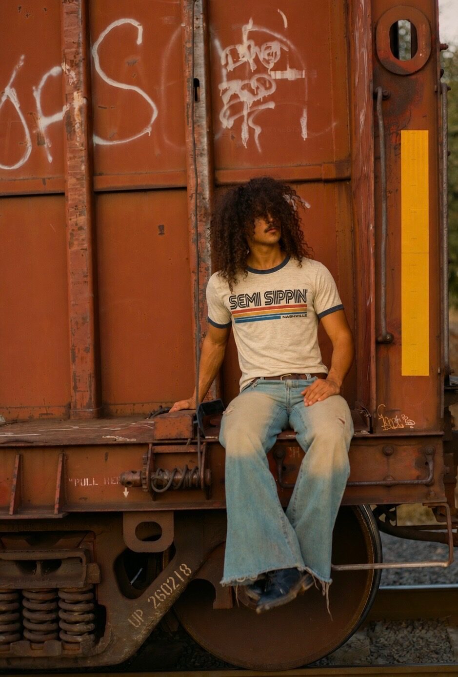 The ringer, worn, late sun, a freight car behind
